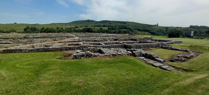 Landscape image of the archaeological ruins of Vindolanda Roman Fort.