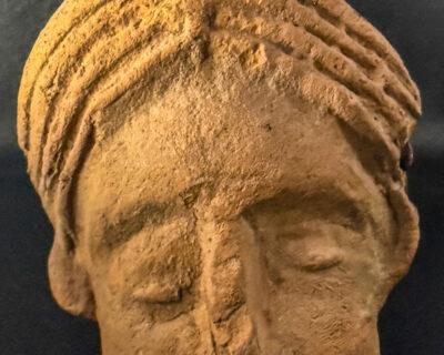 Small head made from terracotta depicting a Roman woman